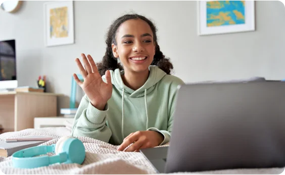 High school sutdent waiving at her online class